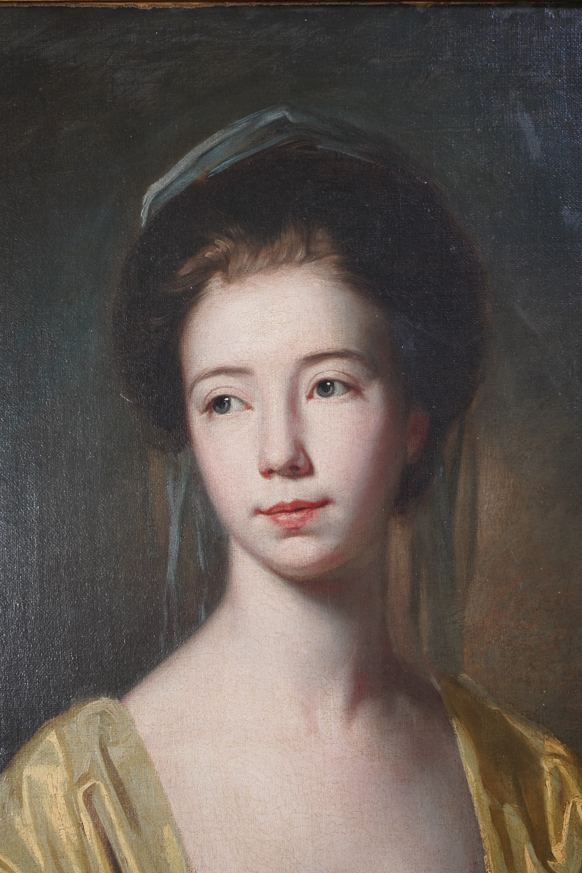 Follower of George Romney, British 1734-1802, A portrait of a young lady with yellow drapery